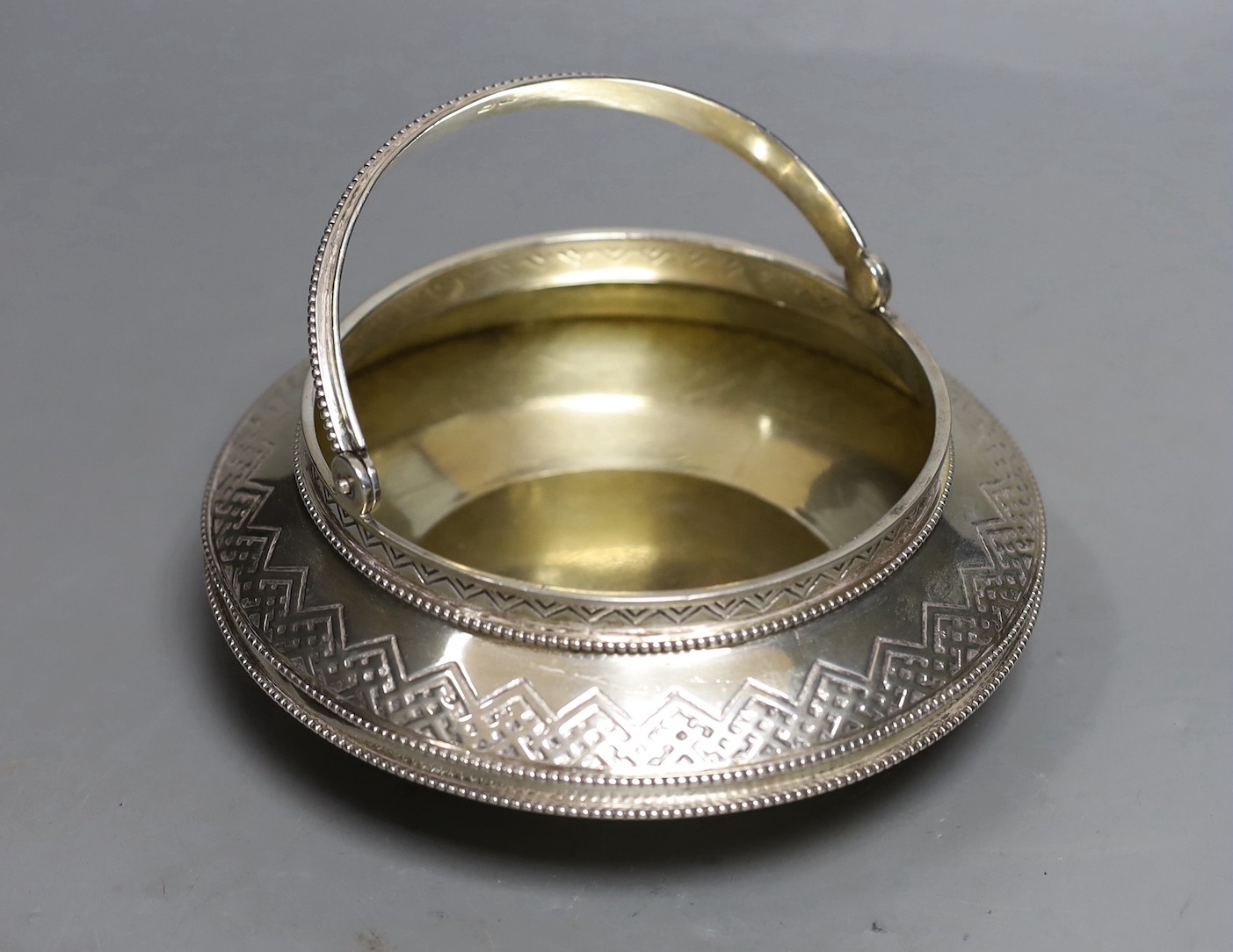 A late 19th century Russian 84 zolotnik sugar basket, of squat circular form, master Aron Berg?, dated 1875, diameter 17cm, 14.6oz.